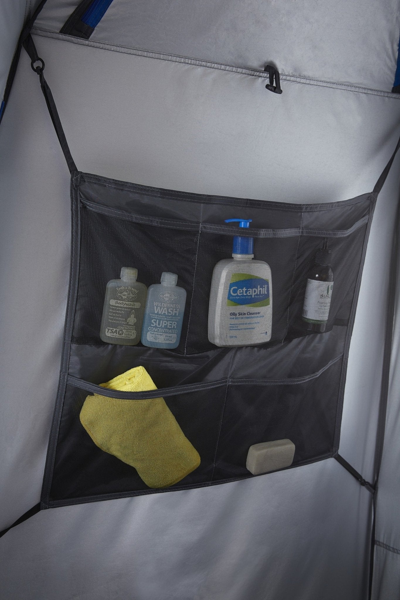 Mesh storage pocket inside the tent holding toiletries