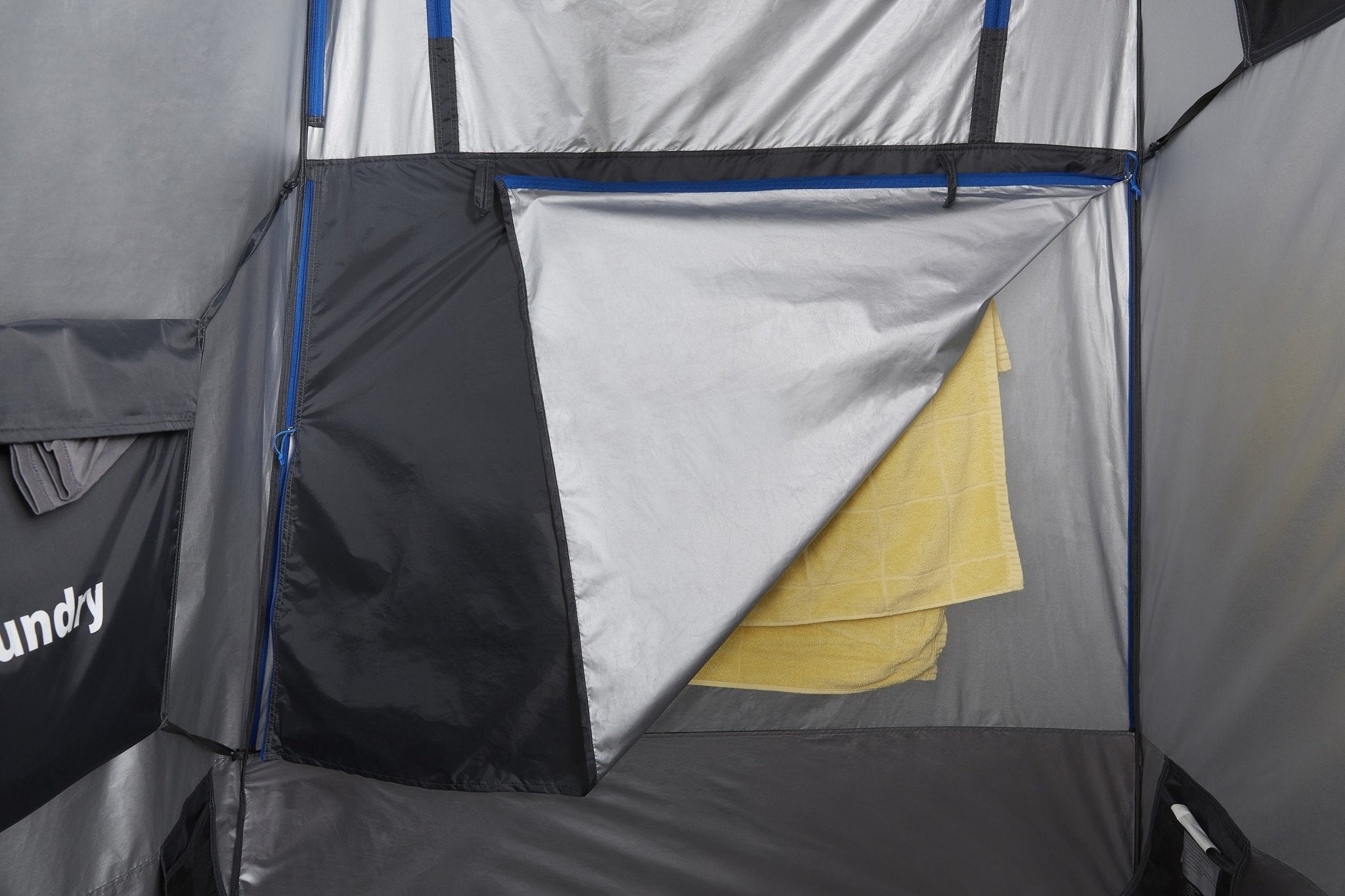 Towel hanging over the dry zone inside the tent, beside the laundry pocket