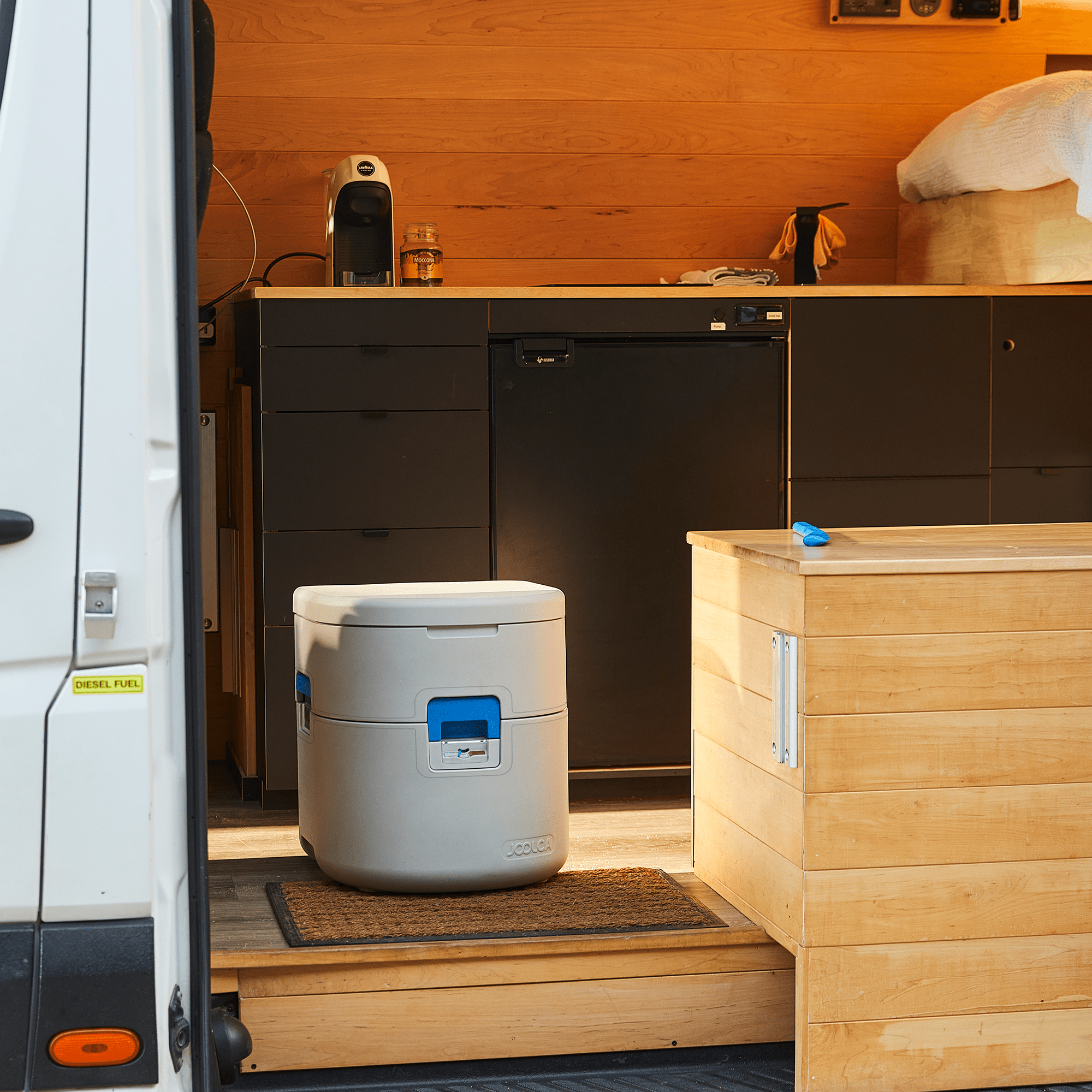 GottaGo portable toilet inside a van beside a timber cabinet