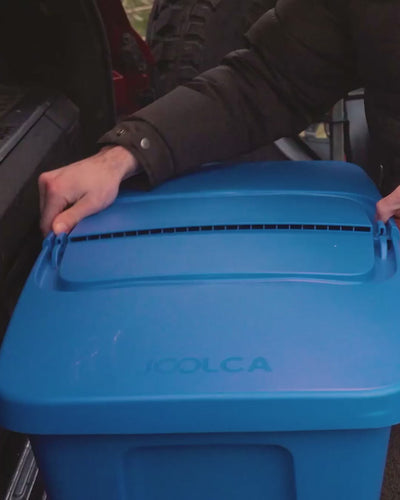 Hand opening a storage tub to reveal the packed HOTTAP V2 unit.
