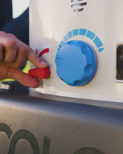 Hand turning the temperature dial on the HOTTAP V2.